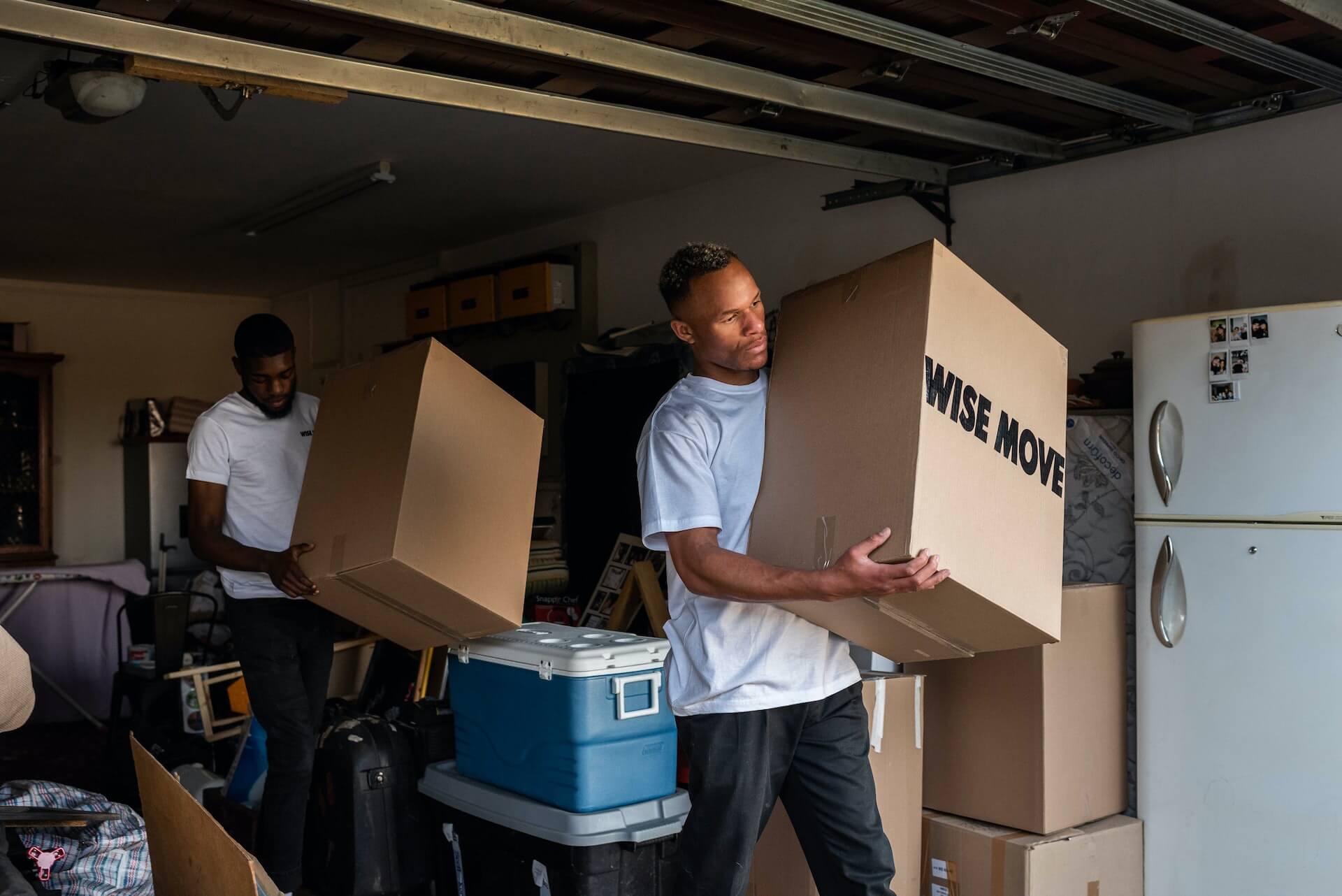 Two man in garage are helping with removal to other place